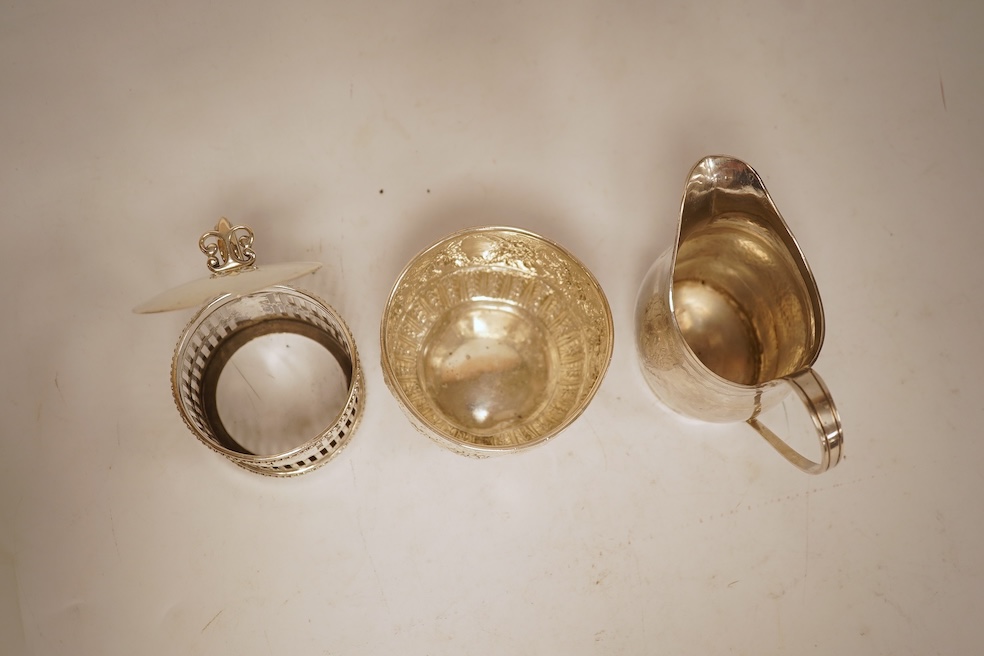 A George III silver helmet shaped cream jug, marks rubbed, 10cm(a.f.), together with a later Victorian silver sugar bowl and similar pierced silver mustard pot, no liner.